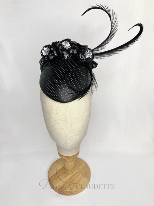 Black leather percher with black leather flowers and three black curled feathers