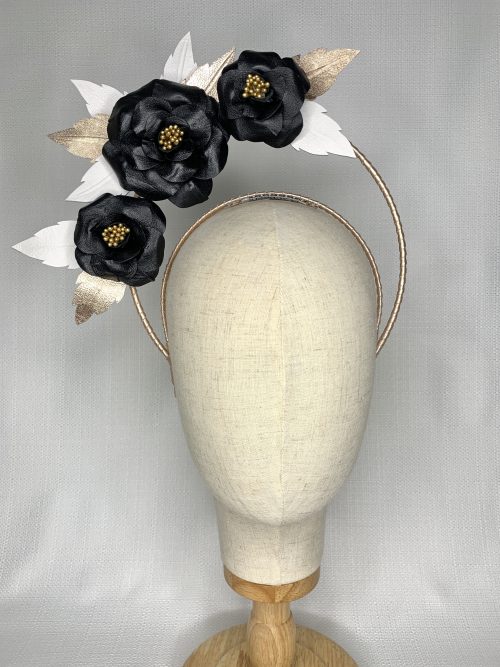 Gold leather bound headband with a halo of three black leather flowers surrounded by hand cut gold and white leaves.