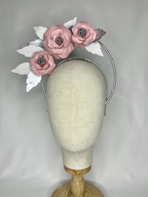 Silver leather bound headband with three pink leather flowers surrounded by silver and white leaves.