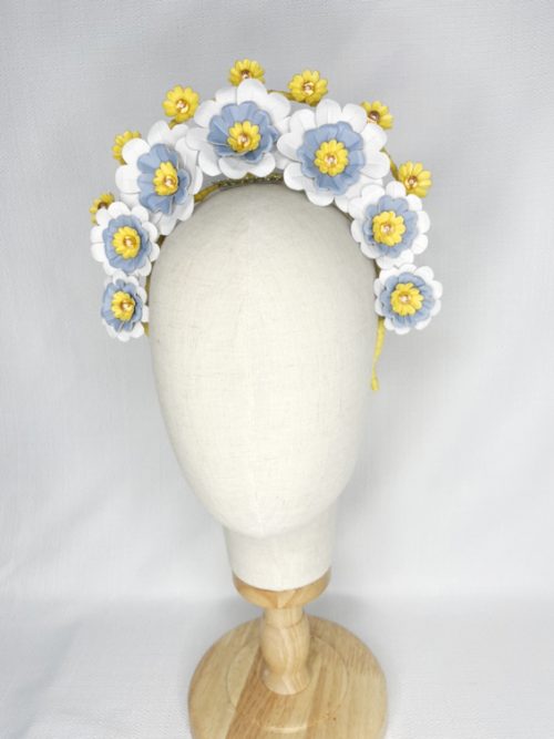 Leather halo headband with yellow, blue and white leather flowers, and small yellow flowers.