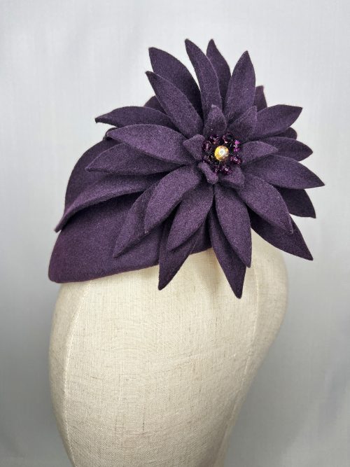 Purple wool felt beret headpiece with large felt flower trim in matching felt fabric.